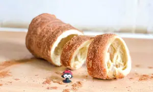 Ktoś pokroił pysznego, cynamonowego **kurtosza**. Obok leży mała biedronka.
