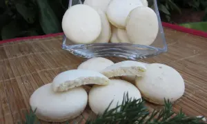 Delikatne, białe anyżki w szklanej misie i na bambusowej macie, ozdobione gałązką iglaka.