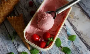 Jak zrobić lody truskawkowe? Pyszne, domowe lody z truskawkami i miętą, gotowe do podania w wafelkach.