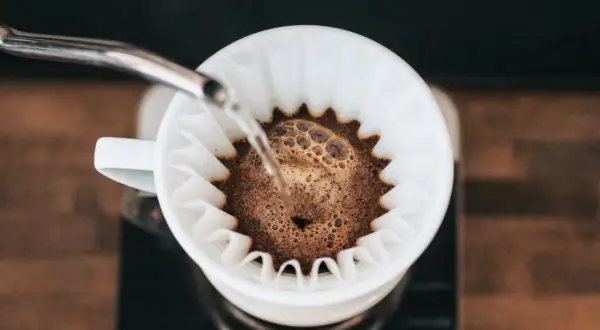 Kawa przelewa się przez filtr, tworząc aromatyczny drip.